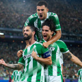 SEVILLE, SPAIN - OCTOBER 14: Isco of Real Betis celebrates after scoring his team's third goal with Marc Bartra and Dani Ceballos during the UEFA Champions League 2026/27 League Phase MD2 match between Real Betis Balompie and FC Porto at Estadio de La Cartuja on October 14, 2026 in Seville, Spain. (Photo by Angel Martinez/Getty Images)