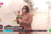 Carla Álvarez, durante su conexión en La Sexta y antes de perder el paraguas por el viento.