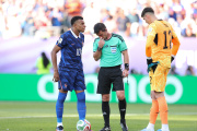 PHILADELPHIA, PENNSYLVANIA - JULY 04: Kylian Mbappe #10 of France checks with Referee Ilgiz Tantashev before placing the ball before a penalty kick while Orlando Gill #12 of Paraguay watches during the FIFA World Cup 2026 Round of 16 match between Paraguay and France at Philadelphia Stadium on July 04, 2026 in Philadelphia, Pennsylvania. (Photo by Dan Mullan/Getty Images)