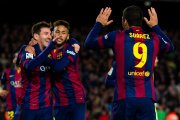 BARCELONA, SPAIN - DECEMBER 07: Lionel Messi (L) of FC Barcelona celebrates with his teammates Neymar Santos Jr (C) and Luis Suarez (R) after scoring his team's second goal during the La Liga match between FC Barcelona and RCD Espanyol at Camp Nou on December 7, 2014 in Barcelona, Spain. (Photo by Alex Caparros/Getty Images)