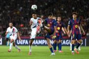 BARCELONA, SPAIN - OCTOBER 01: Senny Mayulu of Paris Saint-Germain and Gerard Martin of FC Barcelona compete for the ball during the UEFA Champions League 2025/26 League Phase MD2 match between FC Barcelona and Paris Saint-Germain at Estadi Olimpic Lluis Companys on October 01, 2025 in Barcelona, Spain. (Photo by David Ramos/Getty Images)