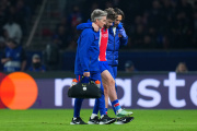 PARIS, FRANCE - OCTOBER 20: Khvicha Kvaratskhelia of Paris Saint-Germain is helped off the pitch by medical staff after sustaining an injury during the UEFA Champions League 2026/27 League Phase MD3 match between Paris Saint-Germain and FC Barcelona at Parc des Princes on October 20, 2026 in Paris, France. (Photo by Franco Arland/Getty Images)