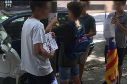 Varios menores repartiendo material de la campaña a favor del SÍ en el referéndum ilegal.