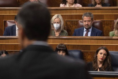 Irene Montero observa seria a Pedro Sánchez, de espaldas a ella.