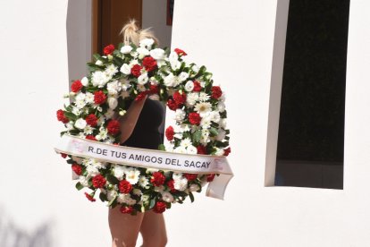 Una persona lleva una corona al sepelio de Julián Muñoz, el pasado 24 de septiembre.