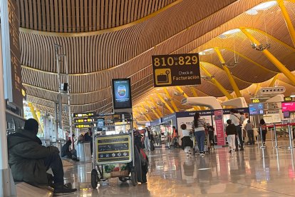 Una persona sin hogar entre los pasajeros de la T4 de Barajas, Madrid, el 13 de mayo de 2025. 