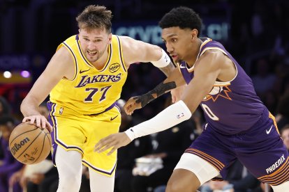 LOS ANGELES, CALIFORNIA - DECEMBER 01:  Luka Doncic #77 of the Los Angeles Lakers controls the ball against Ryan Dunn #0 of the Phoenix Suns in the second half at Crypto.com Arena on December 01, 2025 in Los Angeles, California.  NOTE TO USER: User expressly acknowledges and agrees that, by downloading and or using this photograph, User is consenting to the terms and conditions of the Getty Images License Agreement. (Photo by Ronald Martinez/Getty Images)