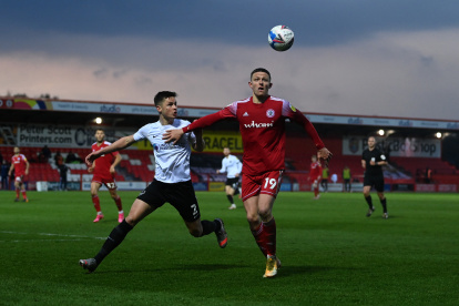 ACCRINGTON, ENGLAND - APRIL 27: Colby Bishop of Accrington is tackled by Callum Johnson of Portsmouth during the Sky Bet League One match between Accrington Stanley and Portsmouth at The Crown Ground on April 27, 2021 in Accrington, England. Sporting stadiums around the UK remain under strict restrictions due to the Coronavirus Pandemic as Government social distancing laws prohibit fans inside venues resulting in games being played behind closed doors. (Photo by Gareth Copley/Getty Images)