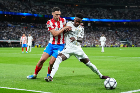 MADRID, SPAIN - APRIL 10: Vinicius Junior of Real Madrid is challenged by Arnau Martinez of Girona FC during the LaLiga EA Sports match between Real Madrid CF and Girona FC at Estadio Santiago Bernabeu on April 10, 2026 in Madrid, Spain. (Photo by Angel Martinez/Getty Images)