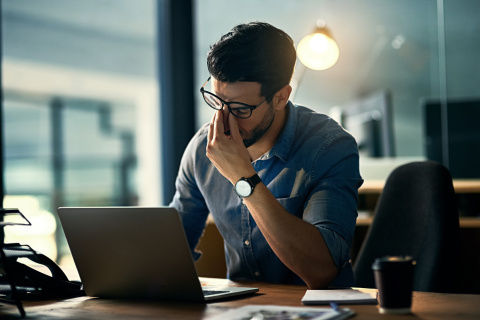 Un hombre se queda en la oficina trabajando horas extra