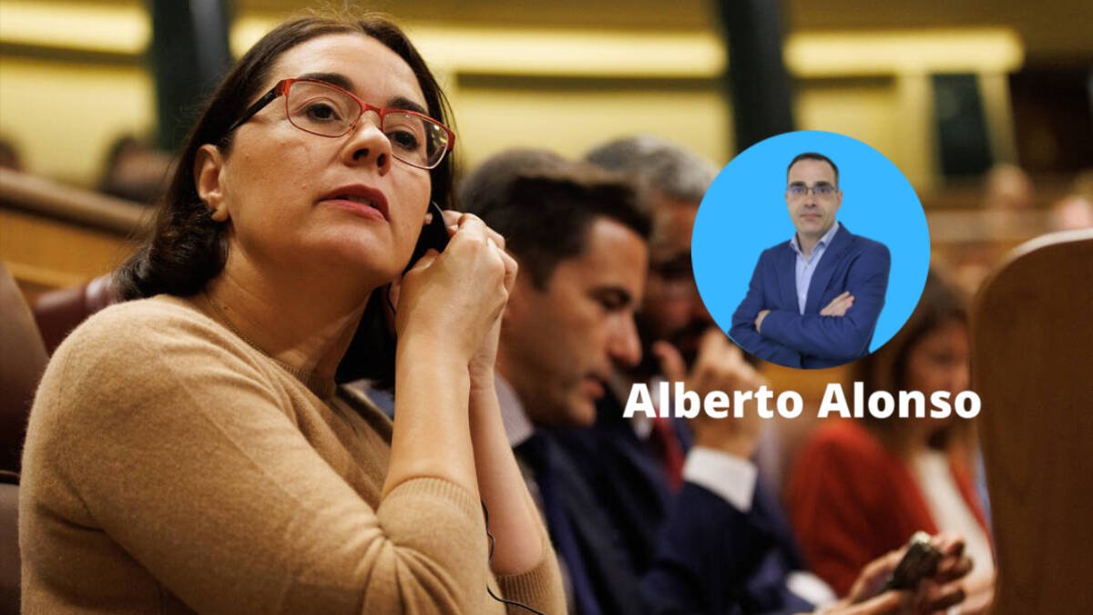 Una diputada se pone el pinganillo durante una sesión en el Congreso de los Diputados.