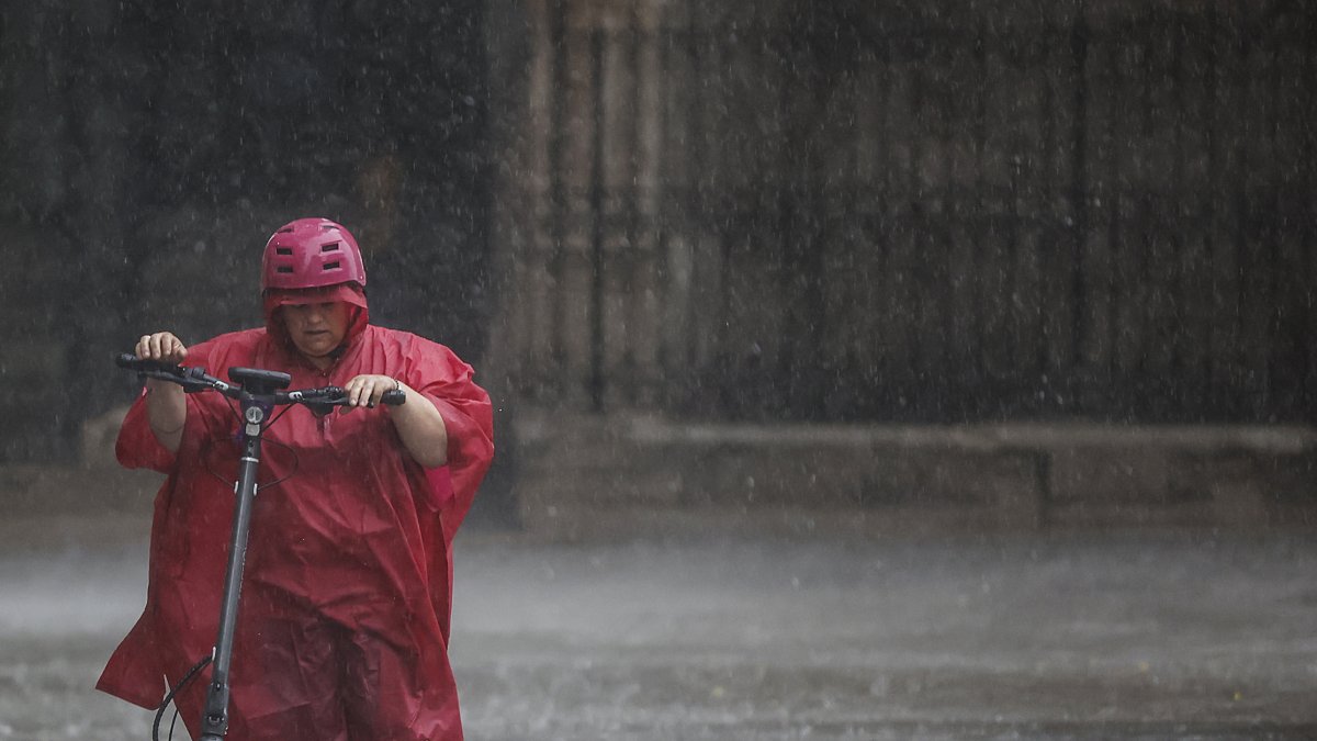 Una persona camina bajo la lluvia