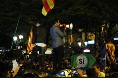 Los Jordis subidos a un vehículo de la Guardia Civil arengando a la multitud.