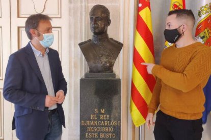 Los concejales de Compromís Natxo Bellido y Rafa Mas junto al busto del rey Emérito Juan Carlos I