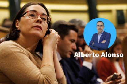 Una diputada se pone el pinganillo durante una sesión en el Congreso de los Diputados.