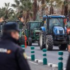 Un agente de Policía Nacional frente a una concentración de tractores en la avenida Germans Machado de Valencia