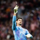 Courtois, recibiendo uno de los objetos que cayó al césped del Metropolitano el pasado domingo.