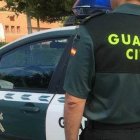 Imagen de archivo de un agente de la Guardia Civil ante un coche patrulla.