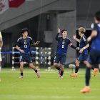 CHOFU, JAPAN - OCTOBER 14: Takumi Minamino of Japan (C) celebrates with teammates after scoring the team's first goal during the international friendly match between Japan and Brazil at Tokyo Stadium on October 14, 2025 in Chofu, Tokyo, Japan. (Photo by Toru Hanai/Getty Images)
