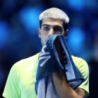 TURIN, ITALY - NOVEMBER 16: Carlos Alcaraz of Spain wipes his face with a towel during the Men's Singles Final against Jannik Sinner of Italy on day eight of the Nitto ATP Finals 2025 at Inalpi Arena on November 16, 2025 in Turin, Italy. (Photo by Clive Brunskill/Getty Images)