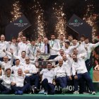 BOLOGNA, ITALY - NOVEMBER 23: Simone Bolelli, Andrea Vavassori, Matteo Berrettini, Lorenzo Sonego, Flavio Cobolli and captain Filippo Volandri of Italy pose for a photo with members of the Italy coaching team after lifting the 'International Lawn Tennis Challenge Trophy' following victory in the Davis Cup Final match between Italy and Spain at BolognaFiere Exhibition Centre on November 23, 2025 in Bologna, Italy. (Photo by Clive Brunskill/Getty Images for ITF)