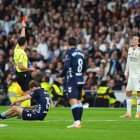MADRID, SPAIN - DECEMBER 07: Alvaro Carreras of Real Madrid is shown a red card by referee, Alejandro Quintero during the LaLiga EA Sports match between Real Madrid CF and RC Celta de Vigo at Estadio Santiago Bernabeu on December 07, 2025 in Madrid, Spain. (Photo by Angel Martinez/Getty Images)