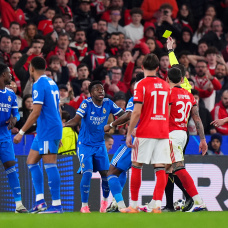 LISBON, PORTUGAL - FEBRUARY 17: Referee Francois Letexier shows a yellow card to Vinicius Junior of Real Madrid after scoring his sides first goal during the UEFA Champions League 2025/26 League Knockout Play-off First Leg match between SL Benfica and Real Madrid C.F. at Estadio do SL Benfica on February 17, 2026 in Lisbon, Portugal. (Photo by Angel Martinez/Getty Images)