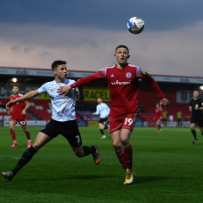 ACCRINGTON, ENGLAND - APRIL 27: Colby Bishop of Accrington is tackled by Callum Johnson of Portsmouth during the Sky Bet League One match between Accrington Stanley and Portsmouth at The Crown Ground on April 27, 2021 in Accrington, England. Sporting stadiums around the UK remain under strict restrictions due to the Coronavirus Pandemic as Government social distancing laws prohibit fans inside venues resulting in games being played behind closed doors. (Photo by Gareth Copley/Getty Images)