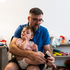 Un padre ayuda a su hijo a vestirse