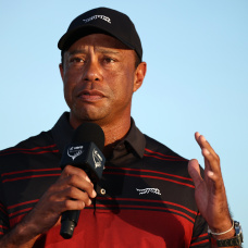 NASSAU, BAHAMAS - DECEMBER 07: Tiger Woods of the United States speaks during the trophy presentation on the 18th green after the final round of the Hero World Challenge 2025 at Albany Golf Course on December 07, 2025 in Nassau, Bahamas. (Photo by Jared C. Tilton/Getty Images)