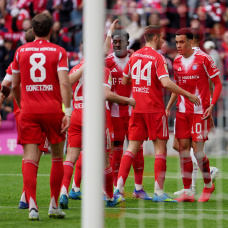 MUNICH, GERMANY - APRIL 19: Raphael Guerreiro of FC Bayern Munich celebrates scoring his team's first goal with teammates during the Bundesliga match between FC Bayern München and VfB Stuttgart at Allianz Arena on April 19, 2026 in Munich, Germany. (Photo by Leonhard Simon/Getty Images)