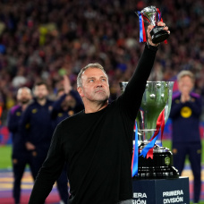 BARCELONA, SPAIN - MAY 10: Hansi Flick, Head Coach of FC Barcelona, lifts a miniature of the LaLiga EA Sports trophy as he celebrates after defeating Real Madrid, and winning the LaLiga title, after the LaLiga EA Sports match between FC Barcelona and Real Madrid CF at Spotify Camp Nou on May 10, 2026 in Barcelona, Spain. (Photo by Alex Caparros/Getty Images)