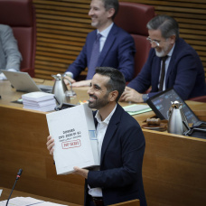 El portavoz socialista, José Muñoz, con un caja de cartón vacía, durante el debate del estado de la Comunidad