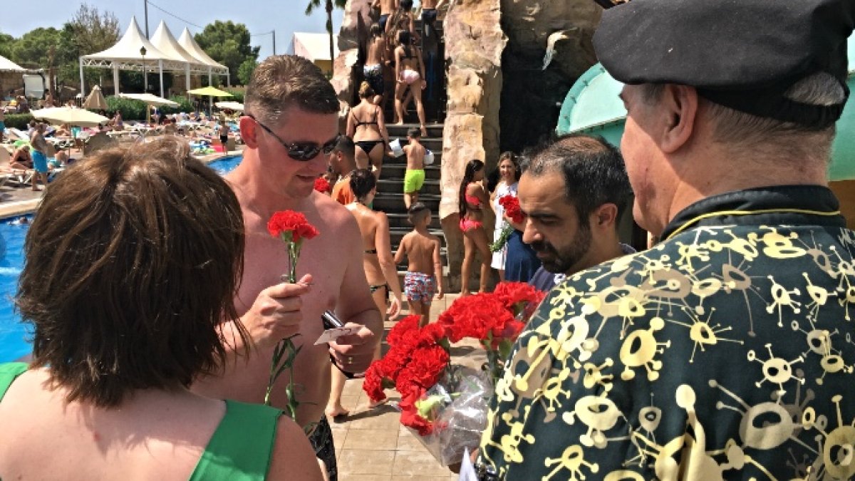 Un turista recibe flores y abrazos.