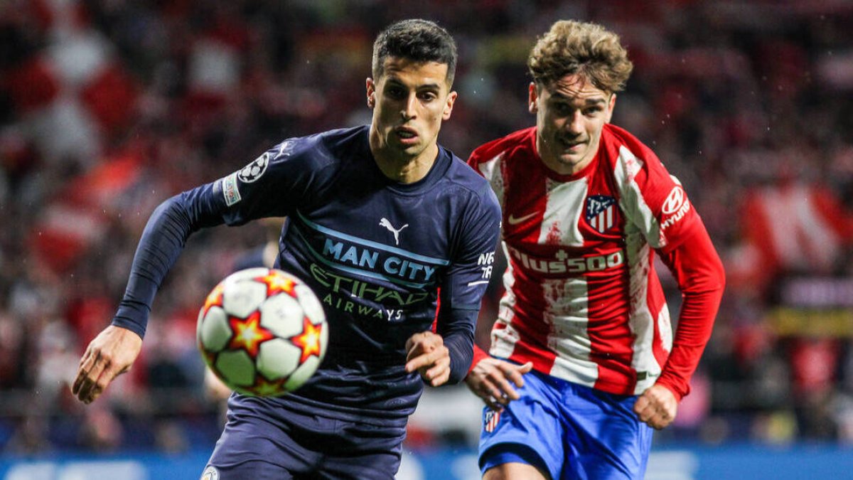 Griezmann persigue un balón en presencia de Cancelo