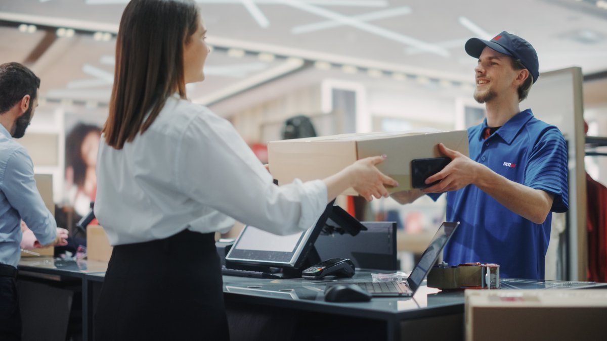 Empleado de MRW haciendo una devolución de un paquete en tienda.