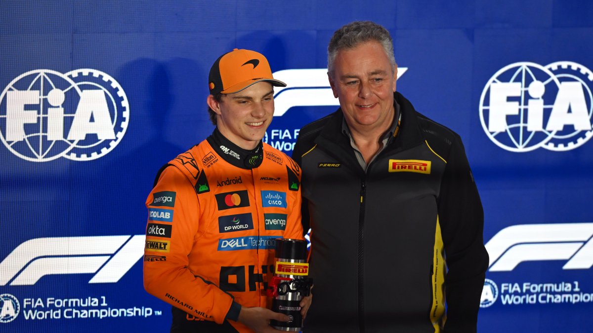 LUSAIL CITY, QATAR - NOVEMBER 28: Sprint Pole qualifier Oscar Piastri of Australia and McLaren receives his Pirelli Sprint Pole award from Mario Isola, Director of Pirelli F1 during Sprint Qualifying ahead of the F1 Grand Prix of Qatar at Lusail International Circuit on November 28, 2025 in Lusail City, Qatar. (Photo by Rudy Carezzevoli/Getty Images)