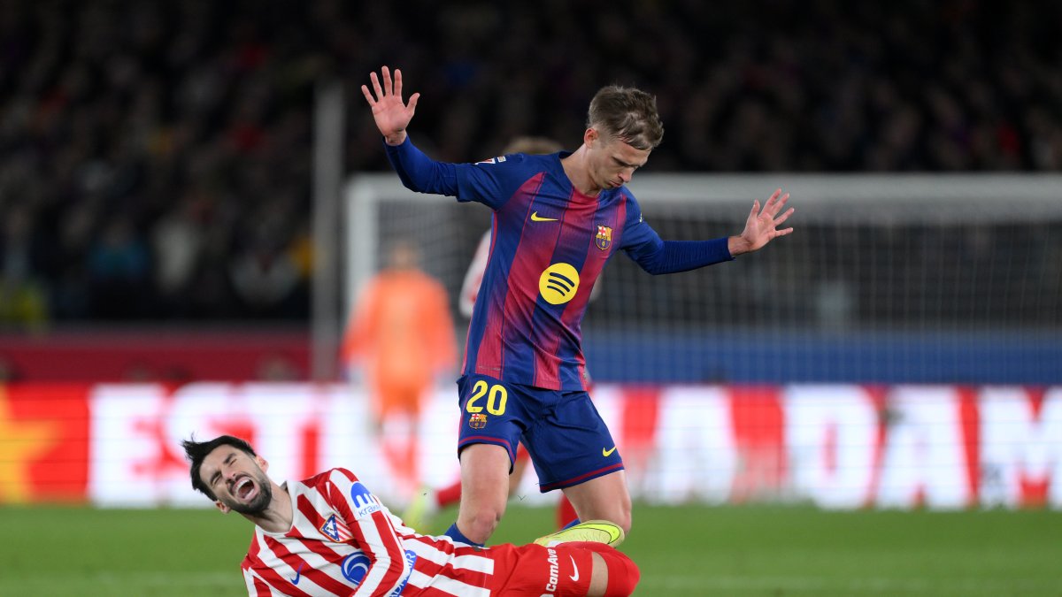 BARCELONA, SPAIN - DECEMBER 02: Alex Baena of Atletico de Madrid is tackled by Dani Olmo of FC Barcelona during the LaLiga EA Sports match between FC Barcelona and Atletico de Madrid at Spotify Camp Nou on December 02, 2025 in Barcelona, Spain. (Photo by David Ramos/Getty Images)