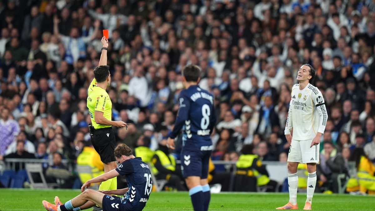 MADRID, SPAIN - DECEMBER 07: Alvaro Carreras of Real Madrid is shown a red card by referee, Alejandro Quintero during the LaLiga EA Sports match between Real Madrid CF and RC Celta de Vigo at Estadio Santiago Bernabeu on December 07, 2025 in Madrid, Spain. (Photo by Angel Martinez/Getty Images)
