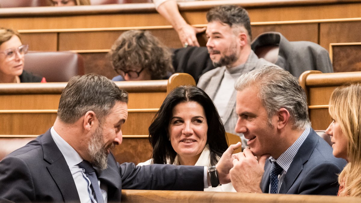 Santiago Abascal bromea con Javier Ortega Smith en el Congreso el 19 de diciembre de 2023.
