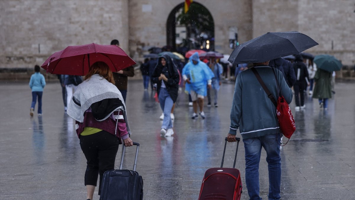 (Foto de ARCHIVO) Varias personas caminan bajo la lluvia en Valencia.