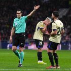 MADRID, SPAIN - FEBRUARY 12: Referee Juan Martinez Munuera gestures for a direct free kick after a handball from Eric Garcia of FC Barcelona during the Copa Del Rey Semi-Final First Leg match between Atletico de Madrid and FC Barcelona at Riyadh Air Metropolitano on February 12, 2026 in Madrid, Spain.  (Photo by Aitor Alcalde/Getty Images)