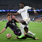 MADRID, SPAIN - MAY 08: Vinicius Jr. of Real Madrid CF competes for the ball with Joshua Kimmich of FC Bayern Munich during the UEFA Champions League semi-final second leg match between Real Madrid and FC Bayern München at Estadio Santiago Bernabeu on May 08, 2024 in Madrid, Spain. (Photo by David Ramos/Getty Images)