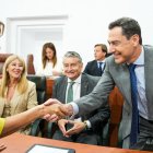 El presidente en funciones de la Junta de Andalucía, Juanma Moreno, saluda a la secretaria general del PSOE-A y portavoz del grupo parlamentario socialista, María Jesús Montero, al inicio de la sesión constitutiva de la XIII Legislatura del Parlamento andaluz.