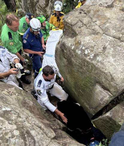 Mujer atrapada entre rocas tratando de recuperar su movil